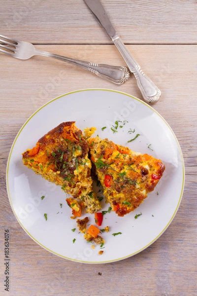 Obraz Frittata made with  eggs, beef sausage, pumpkin (or butternut squash) and red bell pepper. View from above, top, vertical