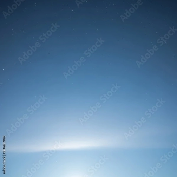 Fototapeta A serene night sky with a gentle glow illuminating the distant horizon and scattered stars above