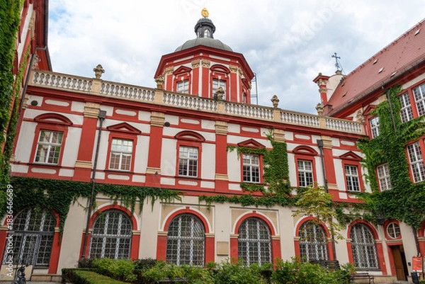 Fototapeta Historic red and white baroque building with ivy-covered walls. Ossoliński National Institute