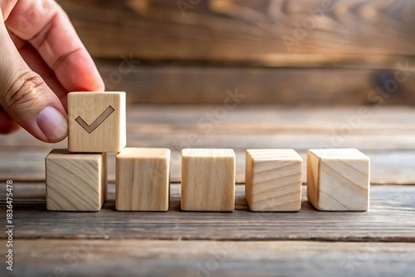 Fototapeta Building Success A Step by Step Process with Wooden Blocks and a Checkmark Symbol Featuring Accomplishment and Wood Grain Texture