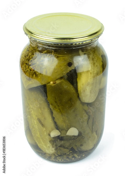 Fototapeta Pickled cucumbers in a glass jar isolated on white