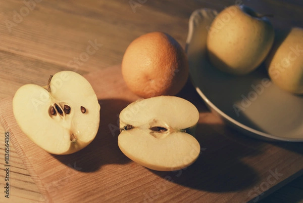 Obraz Apple cut in half, fruit on kitchen table, interior