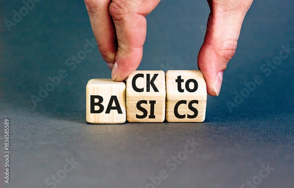 Fototapeta Back to basics symbol. Concept words Back to basics on wooden block. Beautiful grey table grey background. Businessman hand. Business back to basics concept. Copy space.