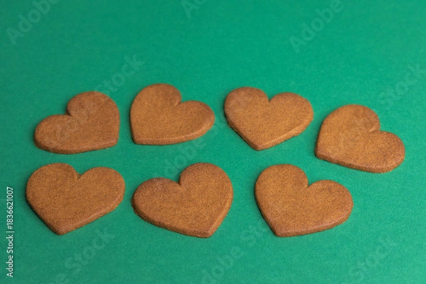Obraz gingerbread hearts on a green background
