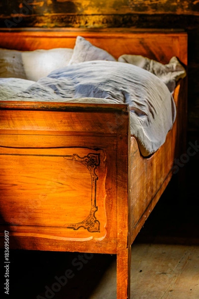 Fototapeta Cozy bed with checkered pillows in a rustic wooden cabin during a serene afternoon