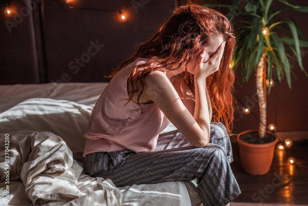 Obraz Sad young woman lying in bed