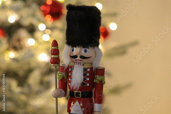 Obraz Editorial image of a nutcracker figure photographed beside a decorated Christmas tree in Novi Sad on December 6, 2025.