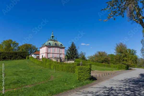 Fototapeta Fasanenschlösschen Pheasant Palace near Moritzburg Castle. Rococo building with a pink facade and turquoise dome against a bright blue sky