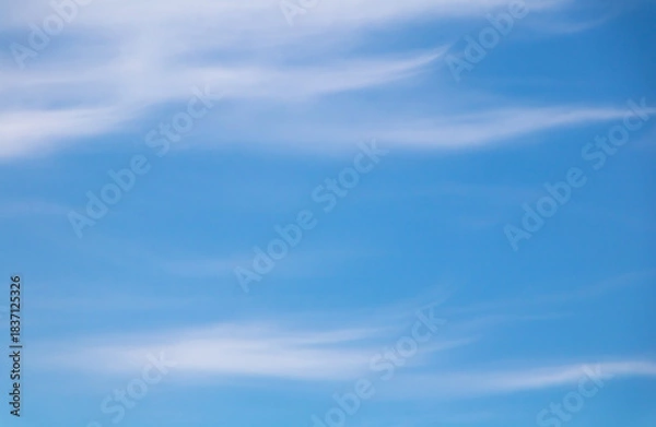 Obraz Bright blue sky background with white artistic clouds.