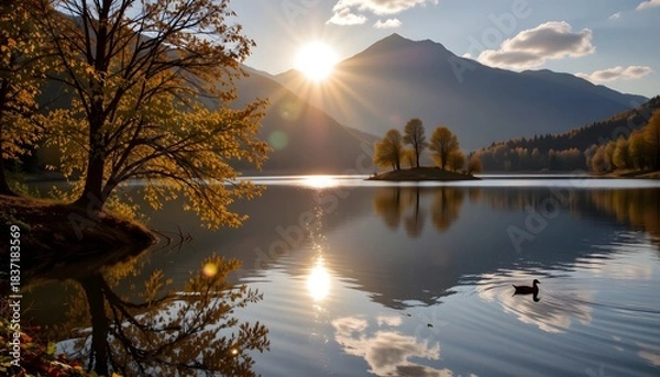 Fototapeta Golden Sunset Over Calm Lake with Island and Mountains Reflected in the Water During Autumn