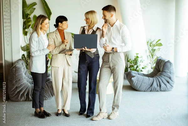 Fototapeta Business team collaborates in modern office space during daytime meeting