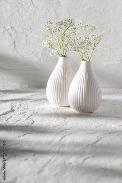 Obraz Stone background and white vase with flowers.
