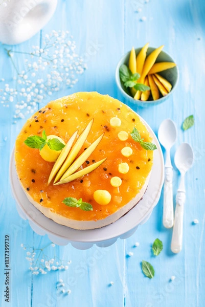 Fototapeta Tasty mango cheesecake made with fruits and mascarpone.