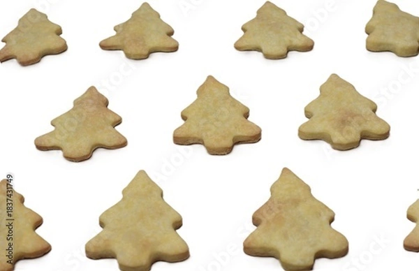 Fototapeta Close-up composition of Christmas tree cookies isolated on a white background. Warm festive baked treats arranged decoratively for holiday design, packaging, and creative seasonal visuals.