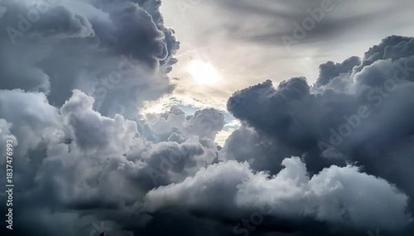 Fototapeta Overcast Sky Background Filled With Dense Gray Clouds With A Faint Bright Spot In The Center Hinting At Diffused Sunlight