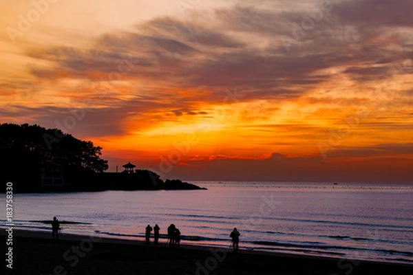Fototapeta background, beach, sunrise, beautiful, nature, beauty, color, abstract, red, songjeong, sky, natural, water, landscape, sea, sun, morning, korea, busan, blue, old, travel, backdrop, architecture, view