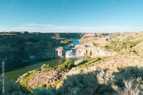 Fototapeta Landscape view of Shoshone Falls as seen from downriver along the edge of the Snake River canyon. Taken in the Shoshone Falls Scenic Area, a public park that includes the waterfall in Twin Falls, ID.