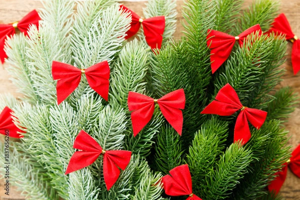 Obraz Red ribbons with pine branches, Christmas tree concept.