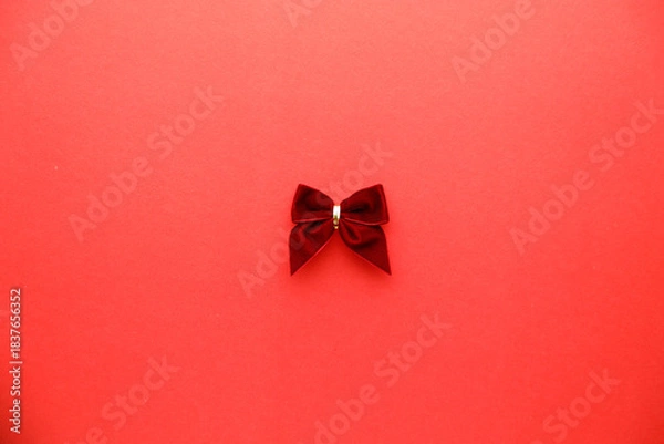 Obraz Red ribbon on red color background. Christmas decoration concept.