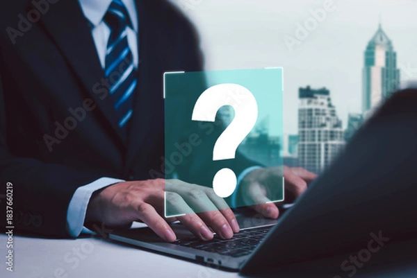 Fototapeta Businessman showing question mark on laptop. Concept of asking, answering, business FAQ, thinking and wondering, brainstorming and problem solving.