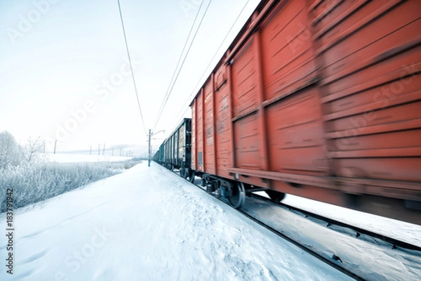 Obraz Winter railway and train with cargo.