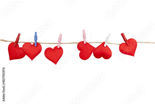 Obraz Red fabric hearts hang on a line with clips. This setup is perfect for creating a decoration for Valentine's Day celebrations at home or in a classroom.