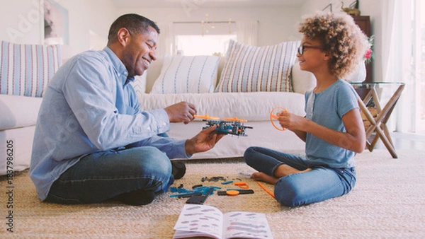 Obraz Grandfather And Granddaughter Sitting On Floor in Lounge At Home Building Construction Kit Together