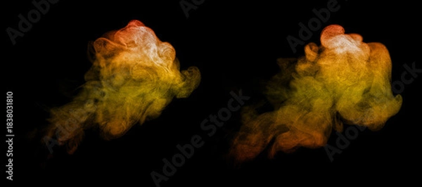 Fototapeta Orange and yellow dust particles forming swirling abstract clouds on a black background, creating a vibrant powder explosion effect ideal for artistic design, digital backgrounds, motion graphics.