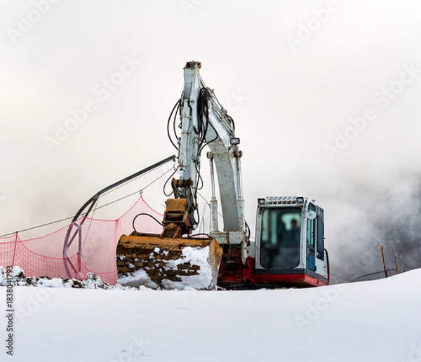 Fototapeta close-up of an excavator working in the snowy mountains