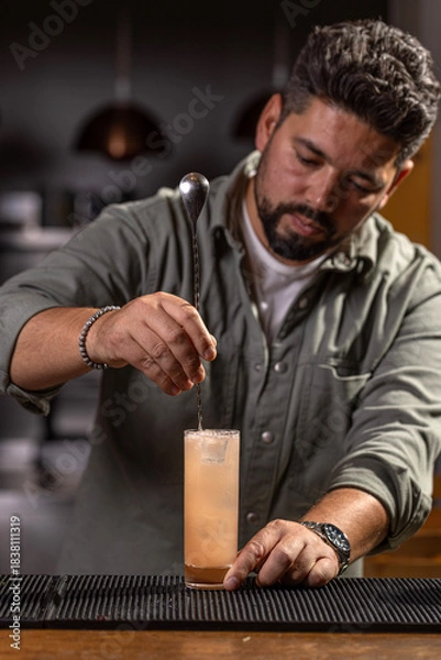 Fototapeta Bartender mixing ingredients