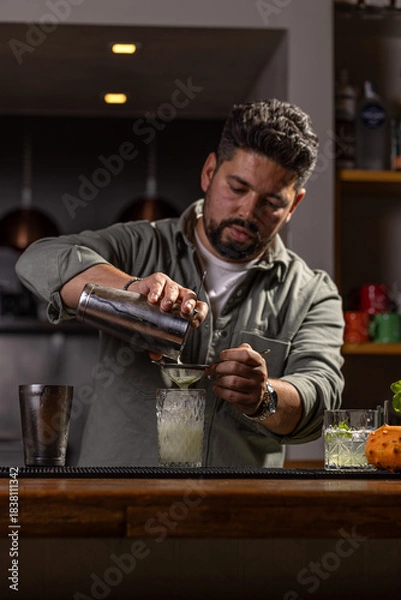 Fototapeta Professional bartender preparing a drink