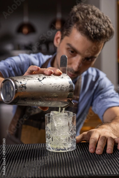 Fototapeta Bartender pouring ingredients