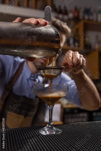 Fototapeta Bartender pouring espresso martini cocktail