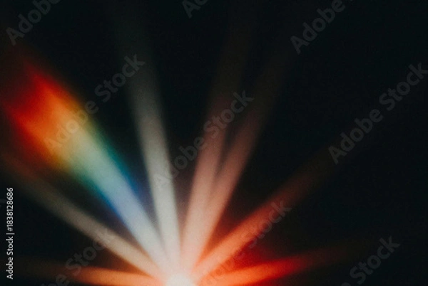 Fototapeta Close up of a colorful light beam on a black background.