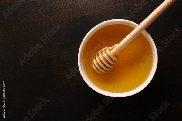 Obraz Honey on a wooden background