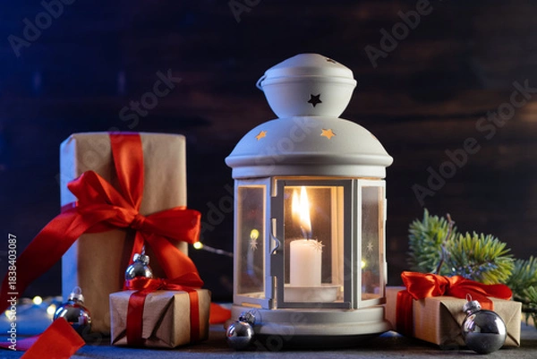 Fototapeta Christmas lantern with red gift boxes on the table