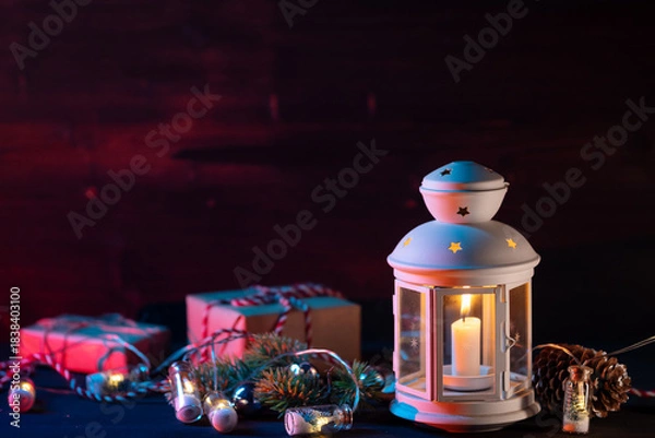 Fototapeta Christmas lantern with gifts, boxes and decorations on a wooden table. Copy space