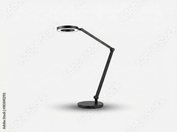 Fototapeta Modern adjustable desk lamp with a circular LED head and thin articulated arm in a matte black finish isolated on white