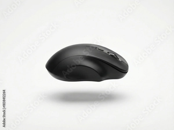 Fototapeta Ergonomic matte black wireless computer mouse with smooth curves suspended and casting a soft shadow on white