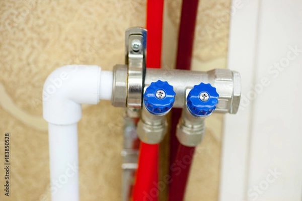 Fototapeta Plumbing from PVC pipes with a hot water collector for connection of a warm floor