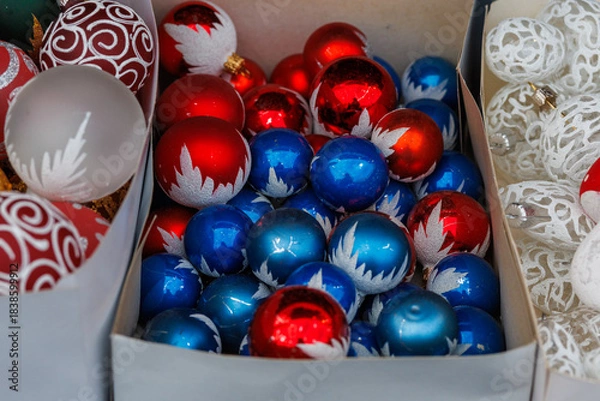 Fototapeta Colorful Christmas baubles with decorative patterns displayed at festive market stall