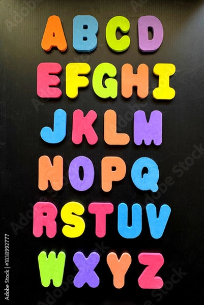 Obraz alphabet colorful foam letters on black background