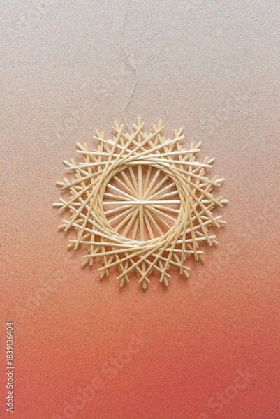 Obraz Snowflakes are made of straw on a orange background. Straw snowflakes. Christmas decor. Straw star. Top view. Straw weaving. Lutsk, Ukraine