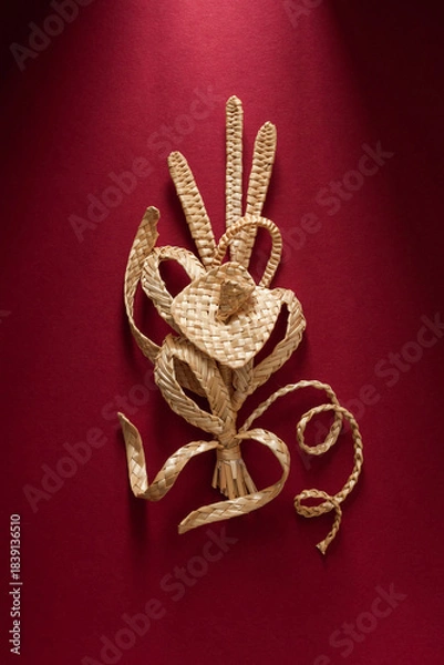 Obraz Decoration of straw on a red background. Branch with flowers. Boutonniere made out of straw. Brooch. Straw weaving.
