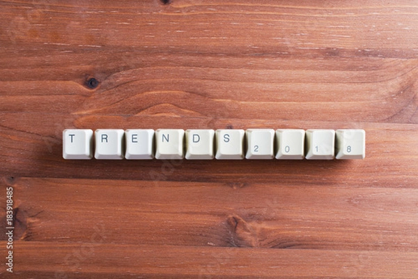 Fototapeta Trends 2018 concept on computer keyboard keys on a wooden background