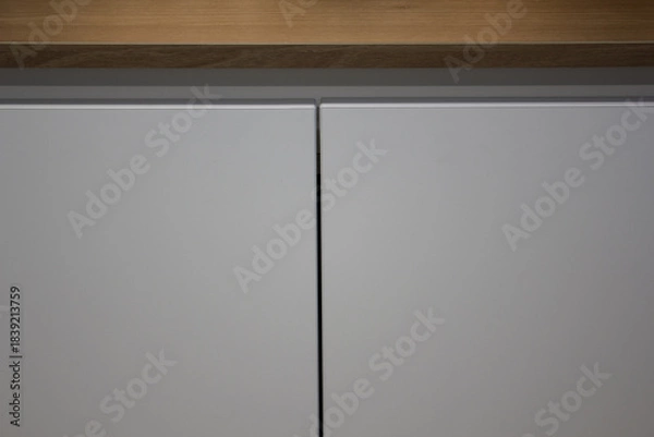 Obraz It's a modern white storage cabinet.