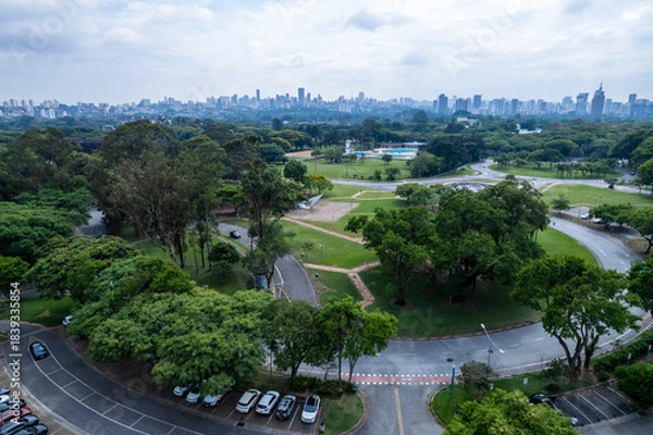 Fototapeta Aerial view of USP campus in Sao Paulo showing buildings, green spaces, and city skyline