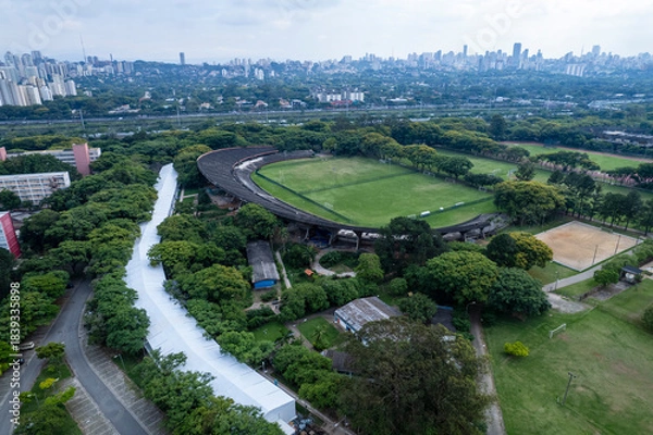 Fototapeta Aerial view of USP campus in Sao Paulo showing buildings, green spaces, and city skyline