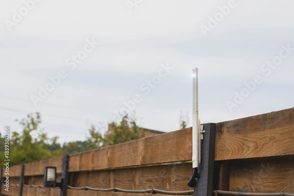 Fototapeta Wi-Fi router outdoor on fence near the house.