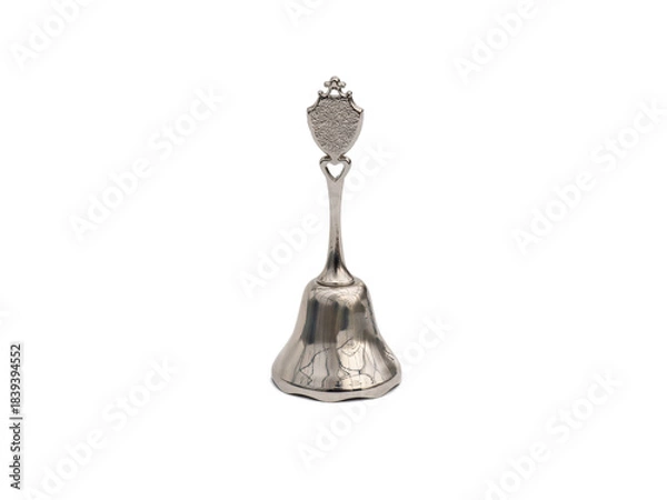Fototapeta Metal souvenir bell. Lunch bell in silver color isolated on white background. Hand call bell for weddings, christmas, school, lunch